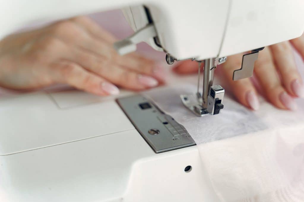 person sewing with a white sewing machine 3984840 pricing